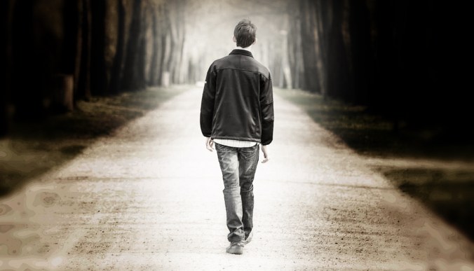 Boy walking on the road in a park